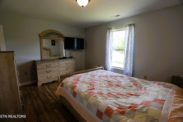 bedroom featuring dark wood-type flooring and baseboards