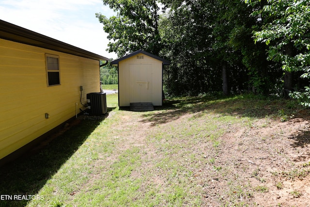 view of green lawn with central AC unit