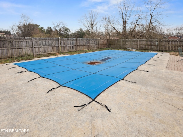 view of swimming pool featuring a patio area, a fenced in pool, and a fenced backyard