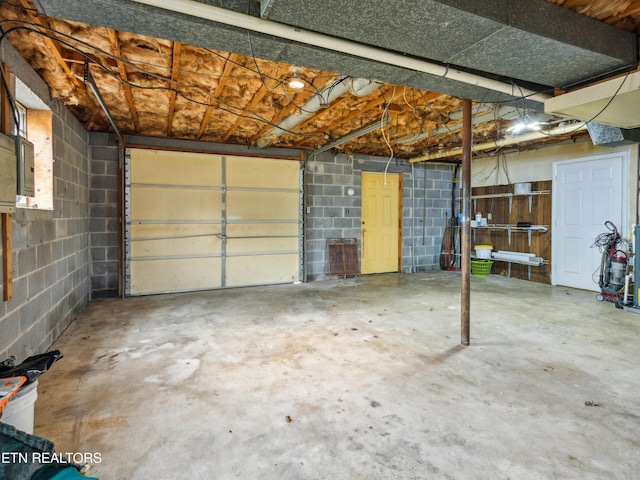 garage with concrete block wall