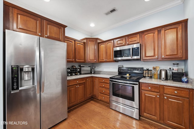 kitchen with light wood-style floors, visible vents, appliances with stainless steel finishes, and brown cabinetry