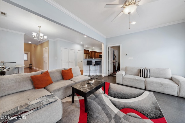 living room featuring recessed lighting, baseboards, visible vents, crown molding, and ceiling fan with notable chandelier