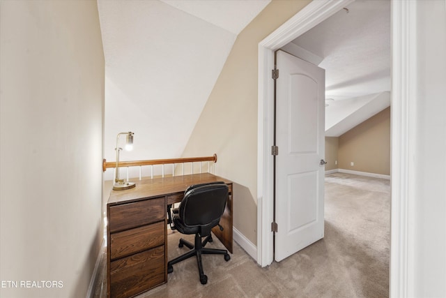 office featuring carpet, vaulted ceiling, and baseboards