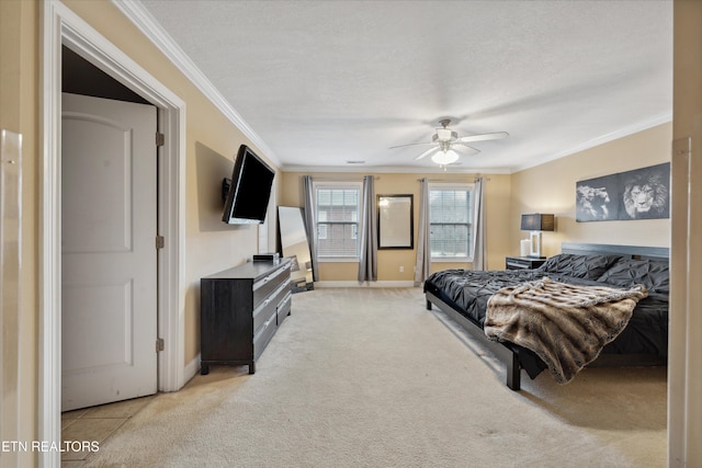 carpeted bedroom with a ceiling fan, baseboards, ornamental molding, and a textured ceiling