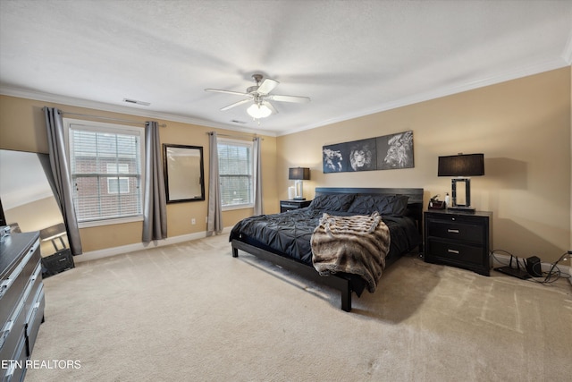 bedroom with crown molding, visible vents, light carpet, ceiling fan, and baseboards