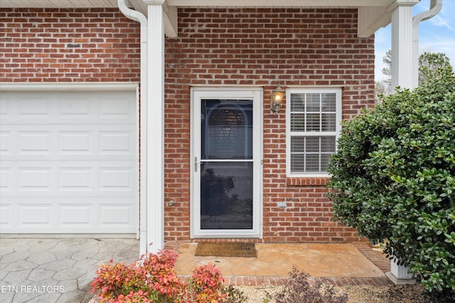 doorway to property with brick siding