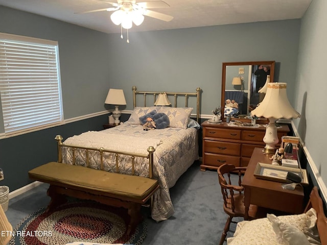 carpeted bedroom featuring ceiling fan and baseboards