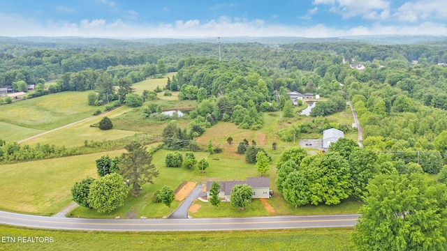 birds eye view of property featuring a forest view