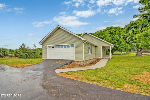 view of home's exterior featuring a garage, a yard, and aphalt driveway