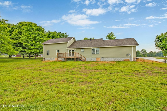 back of house featuring a deck and a yard