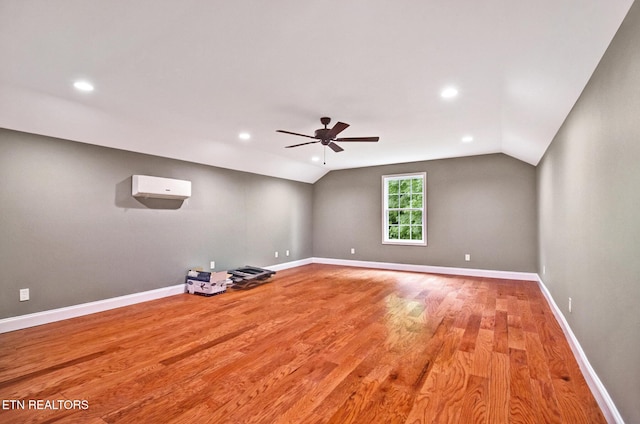 empty room featuring lofted ceiling, ceiling fan, recessed lighting, wood finished floors, and baseboards