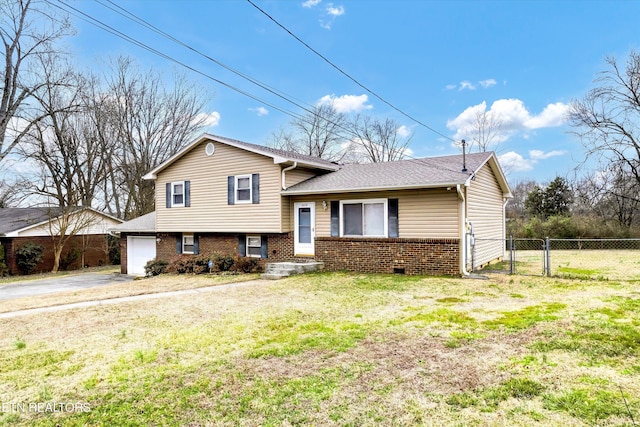 split level home featuring aphalt driveway, brick siding, fence, a gate, and a front lawn