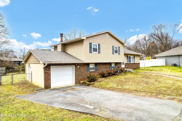 view of front facade with brick siding, an attached garage, a gate, fence, and driveway