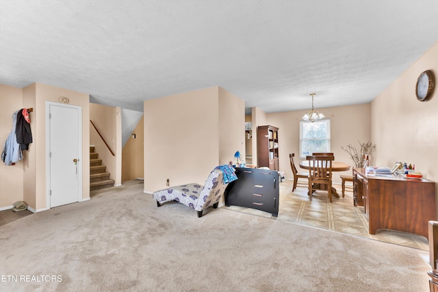 interior space featuring a textured ceiling, stairway, carpet flooring, and an inviting chandelier