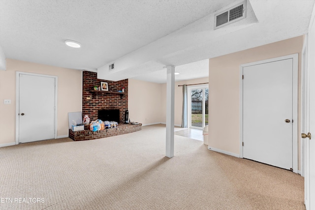 carpeted living area with a brick fireplace, baseboards, visible vents, and a textured ceiling