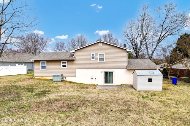 back of property with a yard, an outdoor structure, fence, and central AC unit