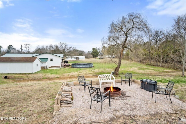 view of yard with an outdoor fire pit