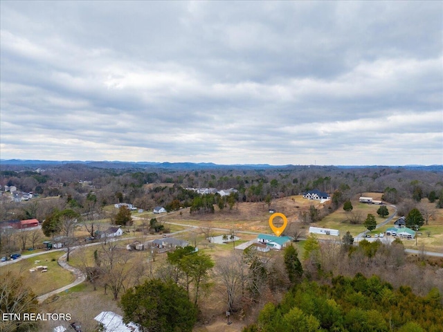 birds eye view of property with a view of trees