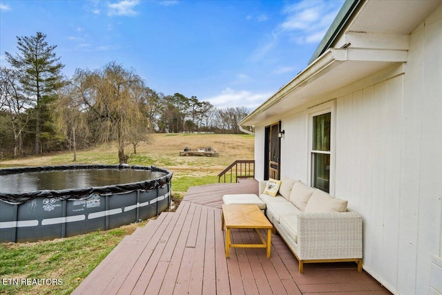 wooden deck with a covered pool and an outdoor hangout area