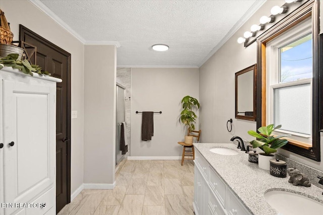 bathroom featuring crown molding, a stall shower, and a sink