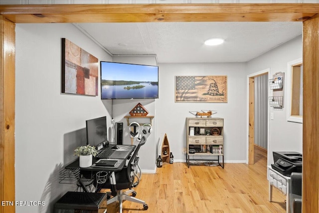 office featuring light wood-type flooring and baseboards