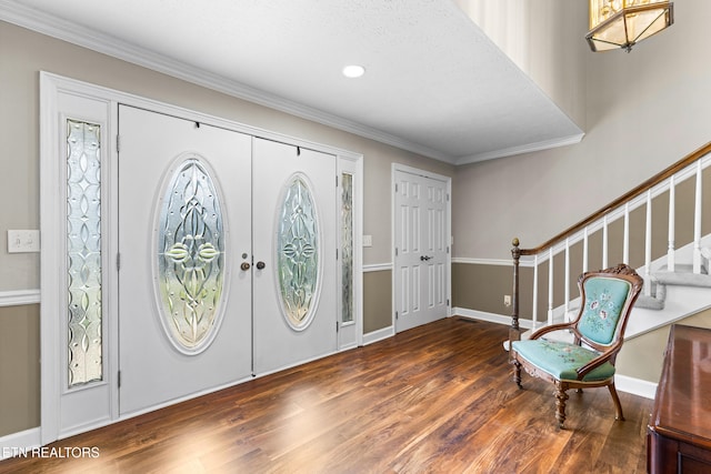 entrance foyer featuring stairs, wood finished floors, french doors, and ornamental molding