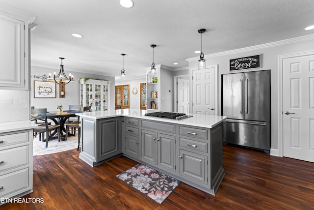 kitchen with dark wood-style floors, gray cabinets, stainless steel appliances, light countertops, and a center island