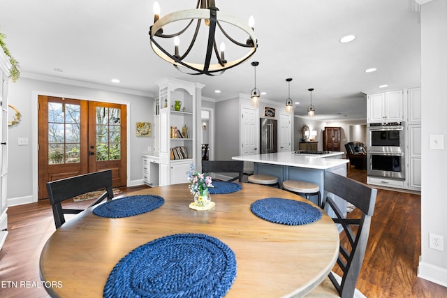 dining space with recessed lighting, french doors, dark wood-type flooring, and crown molding