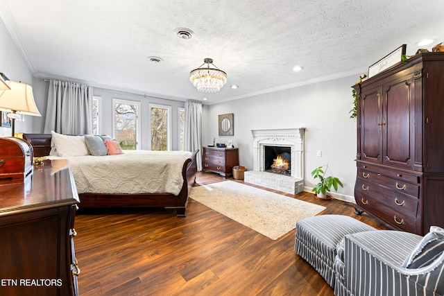 bedroom with dark wood finished floors, visible vents, a brick fireplace, and crown molding