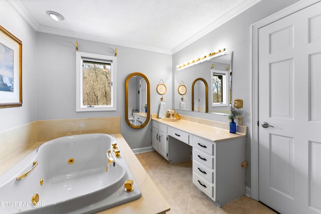 bathroom featuring vanity, ornamental molding, tile patterned floors, a tub with jets, and a textured ceiling