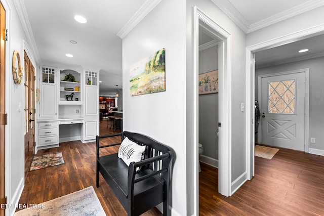 corridor featuring dark wood-type flooring, recessed lighting, baseboards, and ornamental molding