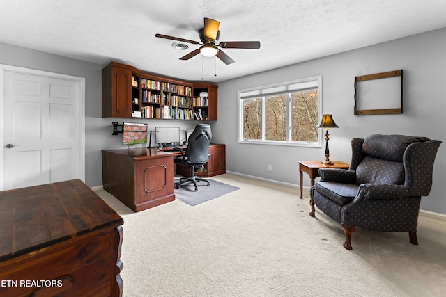 office area featuring baseboards, carpet floors, a textured ceiling, and a ceiling fan