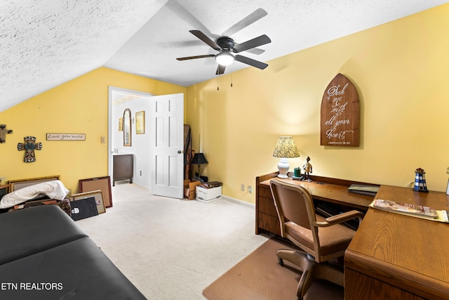 home office with lofted ceiling, a ceiling fan, a textured ceiling, carpet floors, and baseboards