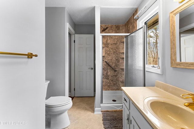 full bath with tile patterned floors, toilet, a stall shower, and vanity