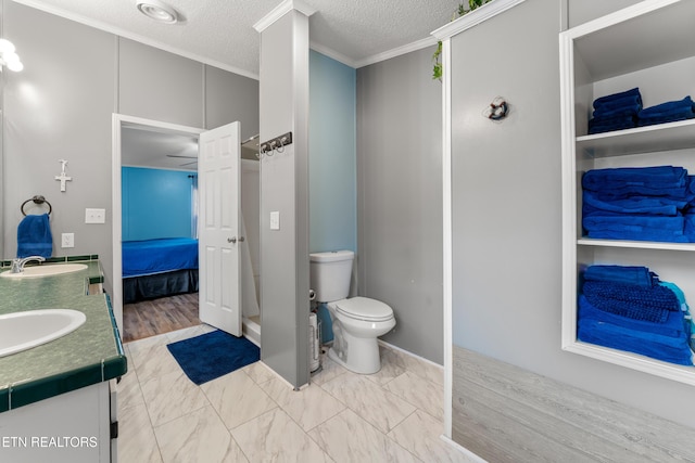 full bathroom with double vanity, toilet, ensuite bathroom, and a sink