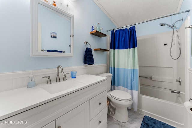 full bathroom with toilet, shower / bath combo with shower curtain, vanity, marble finish floor, and a textured ceiling