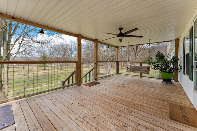 wooden deck featuring ceiling fan