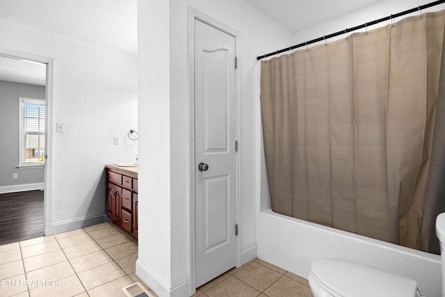 bathroom with visible vents, toilet, vanity, tile patterned flooring, and baseboards