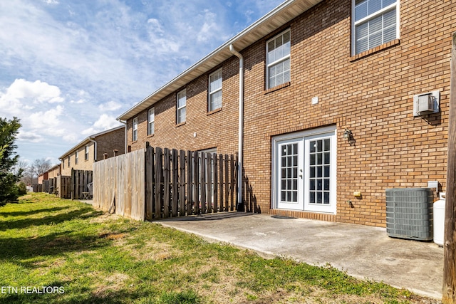 view of property featuring fence, cooling unit, and an AC wall unit