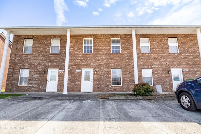 view of property featuring uncovered parking