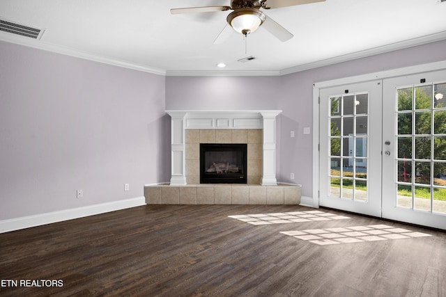 unfurnished living room featuring baseboards, visible vents, crown molding, and wood finished floors