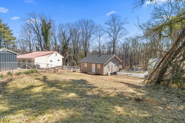 view of yard with an outdoor structure and fence