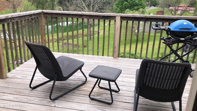 wooden terrace with a yard