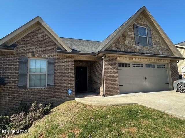 view of front of house featuring brick siding, concrete driveway, and a garage