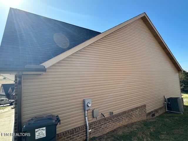 view of side of home featuring central AC unit