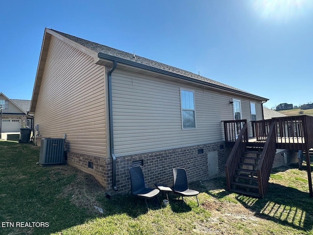 view of side of property featuring central air condition unit, stairs, a lawn, a deck, and crawl space