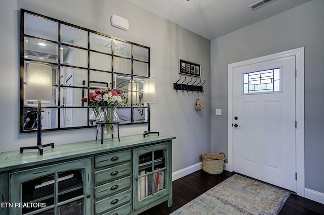 entrance foyer featuring dark wood-style flooring, visible vents, and baseboards