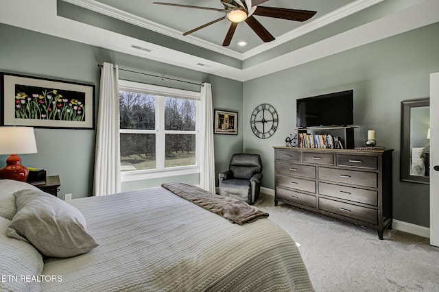 bedroom with baseboards, visible vents, a raised ceiling, light colored carpet, and crown molding