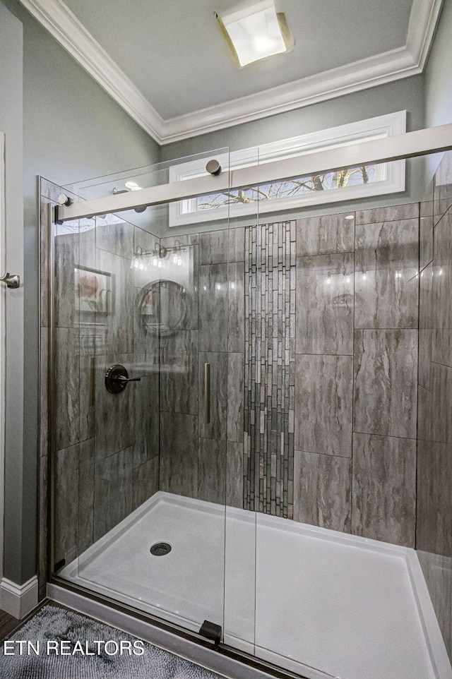 bathroom with ornamental molding and a stall shower