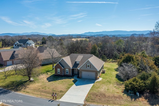 birds eye view of property with a mountain view and a wooded view